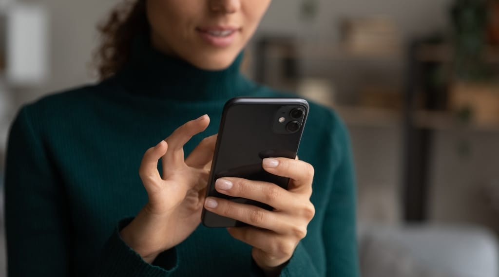 a woman using her phone in a personalised marketing experience