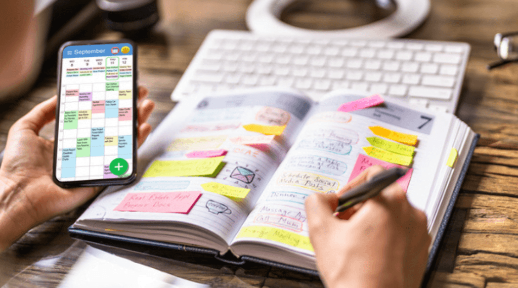 someone writing and scheduling a marketing plan in a diary