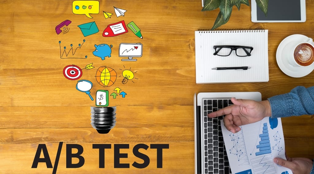 A stylised image of A/B testing, a man with a laptop at a desk with cartoon images and the word 'A/B Test'