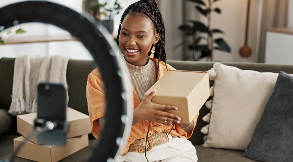 A woman reviews a product videoing it on her phone