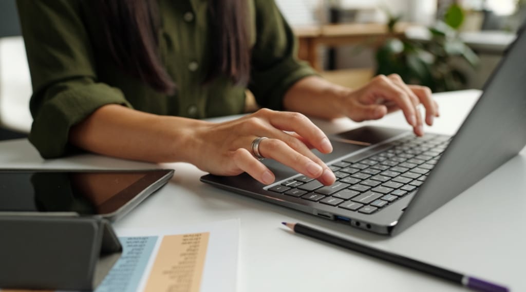 Someone writing an optimised blog on a laptop